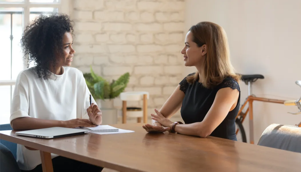Two people in a supportive one-on-one conversation